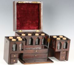 A George III mahogany apothecary's cabinet, the hinged lid and double-hinged front enclosing a set