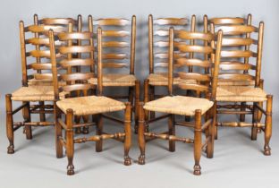 A set of eight late 20th century ash framed ladder back dining chairs with woven rush seats,
