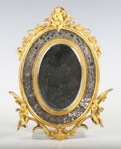 An early 20th century French gilt bronze oval wall mirror, the frame applied with three cherubic