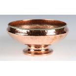 An early 20th century Arts and Crafts copper bowl by Hugh Wallis, the hammered body with applied