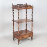 A mid-Victorian rosewood three-tier whatnot with a pierced fretwork gallery and single drawer,