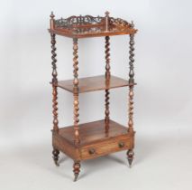 A mid-Victorian rosewood three-tier whatnot with a pierced fretwork gallery and single drawer,