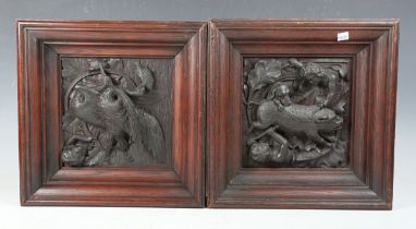 A pair of late 19th century oak wall panels, each finely carved in deep relief with cherubic figures