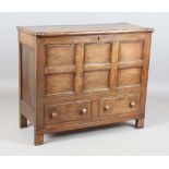 A George III provincial oak mule chest, the removable lid above a panelled front and two drawers,