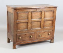 A George III provincial oak mule chest, the removable lid above a panelled front and two drawers,