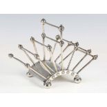 A late Victorian Aesthetic Movement plated six-division toast rack, designed by Christopher