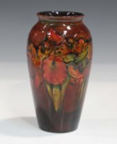A Moorcroft flambé orchid pattern vase, circa 1928-49, impressed marks to base, height 18.5cm.