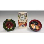 Three pieces of Moorcroft pottery, comprising a Butterfly pattern clock, circa 1993, height 15.