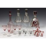 A pair of Art Deco faceted clear glass decanters and stoppers of conical shape with white