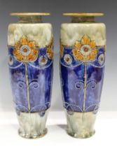 A pair of Royal Doulton stoneware vases, early 20th century, decorated with Art Nouveau sunflowers