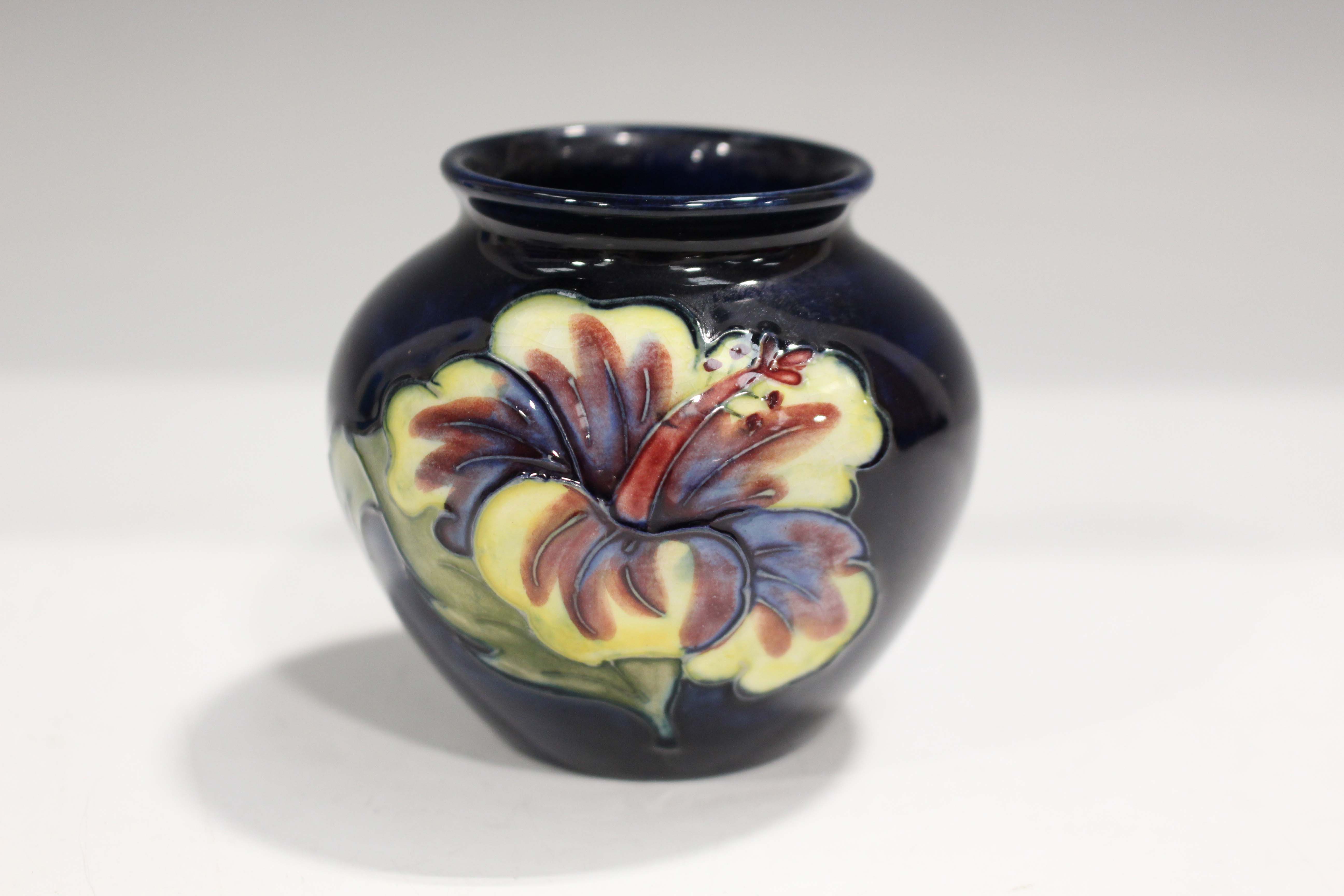 A Moorcroft Pottery Hibiscus pattern cobalt blue ground vase of bulbous shape, applied paper label - Image 3 of 3