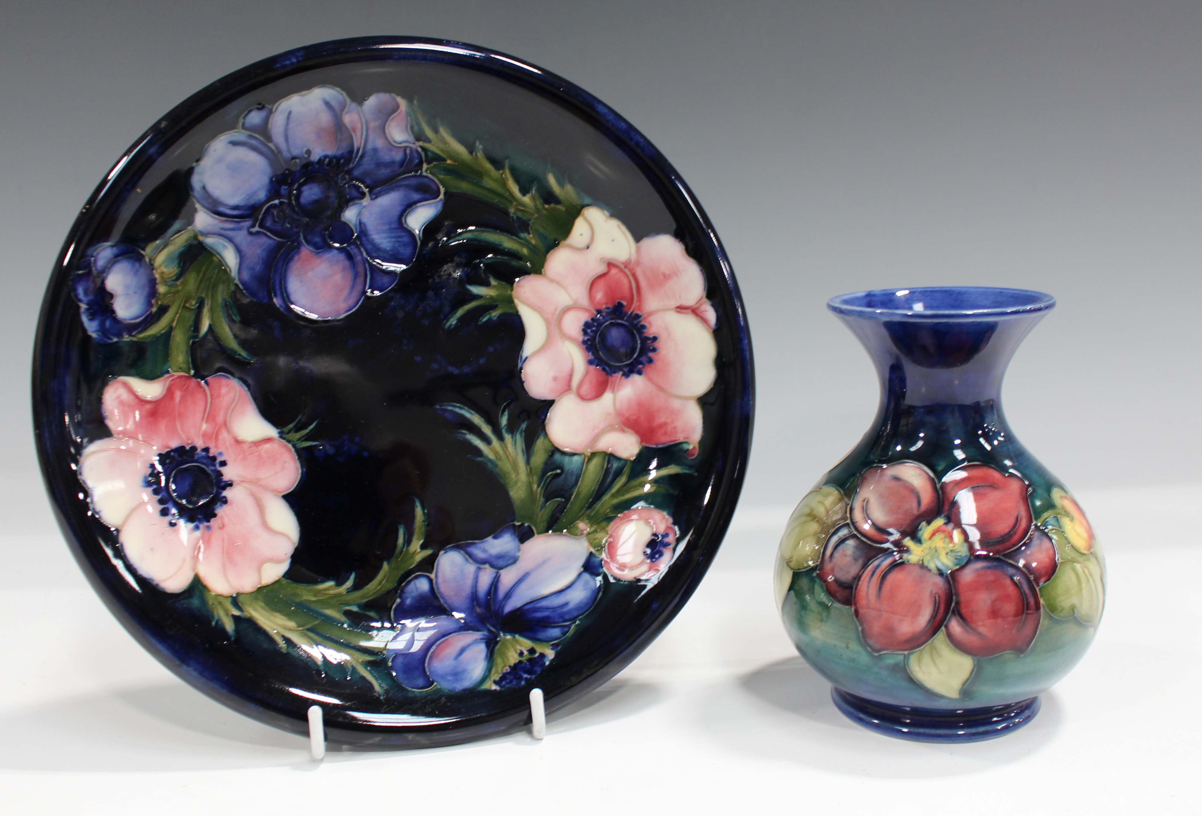 A Moorcroft dark blue ground Anemone pattern plate, mid-20th century, impressed facsimile