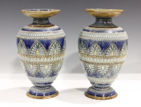 A pair of Doulton Lambeth stoneware vases, dated 1883, decorated in low relief with geometric banded