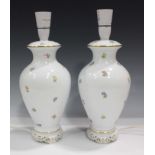 A pair of Herend porcelain table lamp bases, 20th century, of baluster shape, painted with scattered