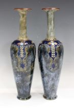 A pair of tall Royal Doulton stoneware vases, early 20th century, the slender bodies with stylized