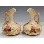 A pair of Royal Worcester floral decorated blush ivory jugs, dated 1902, shape No. 1136, green