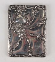 A late Victorian silver rectangular card case embossed with scrolling stems and flowers,