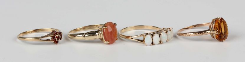 A gold and opal five stone ring, claw set with a row of oval opals, indistinct mark, weight 2.9g,