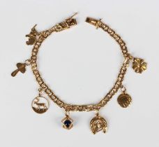 A Swedish gold charm bracelet, fitted with seven charms, including an elephant and a four leaf