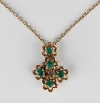 A 9ct gold and emerald pendant, designed as five flowerheads, each claw set with a circular cut