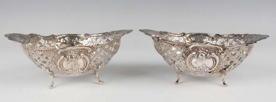 A pair of late Victorian silver oval bonbon dishes, each cast and pierced with opposing 'C' scroll