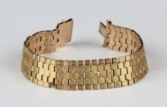 A 9ct gold wide bracelet with a textured finish, on a snap clasp, weight 20.4g, length 18cm (