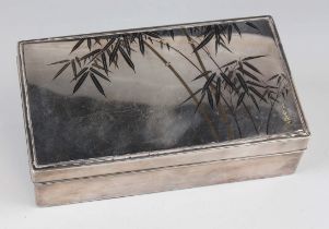 A Japanese silver and niello rectangular cigarette box, the lid decorated with stems of bamboo