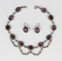 A silver, mauve and colourless paste necklace in an oval cluster link design, the front with pendant