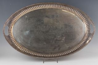 A late Victorian silver oval two-handled tea tray, inscription engraved 'Presented to the Revd W.V.