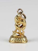 A gold cased bloodstone pendant fob seal, designed as Hercules fighting the Nemean lion, monogram
