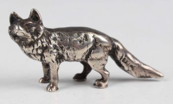 A small cast silver model of a standing fox with fur detail, indistinct marks, weight 48.9g,