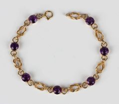 A 9ct gold and amethyst bracelet in a multiple link design, claw set with seven circular cut