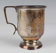 An Arts and Crafts silver christening tankard of cylindrical form, engraved with a band of upright