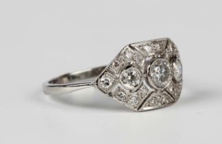A platinum and diamond ring in a pierced geometric Art Deco inspired design, collet set with the
