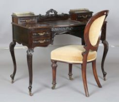 A late Victorian mahogany writing table by Maple & Co, the sliding writing surface revealing a