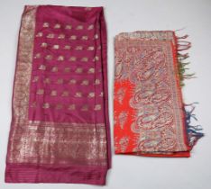 A small group of Indian textiles, comprising a purple silk and gilt thread saree, a paisley cotton