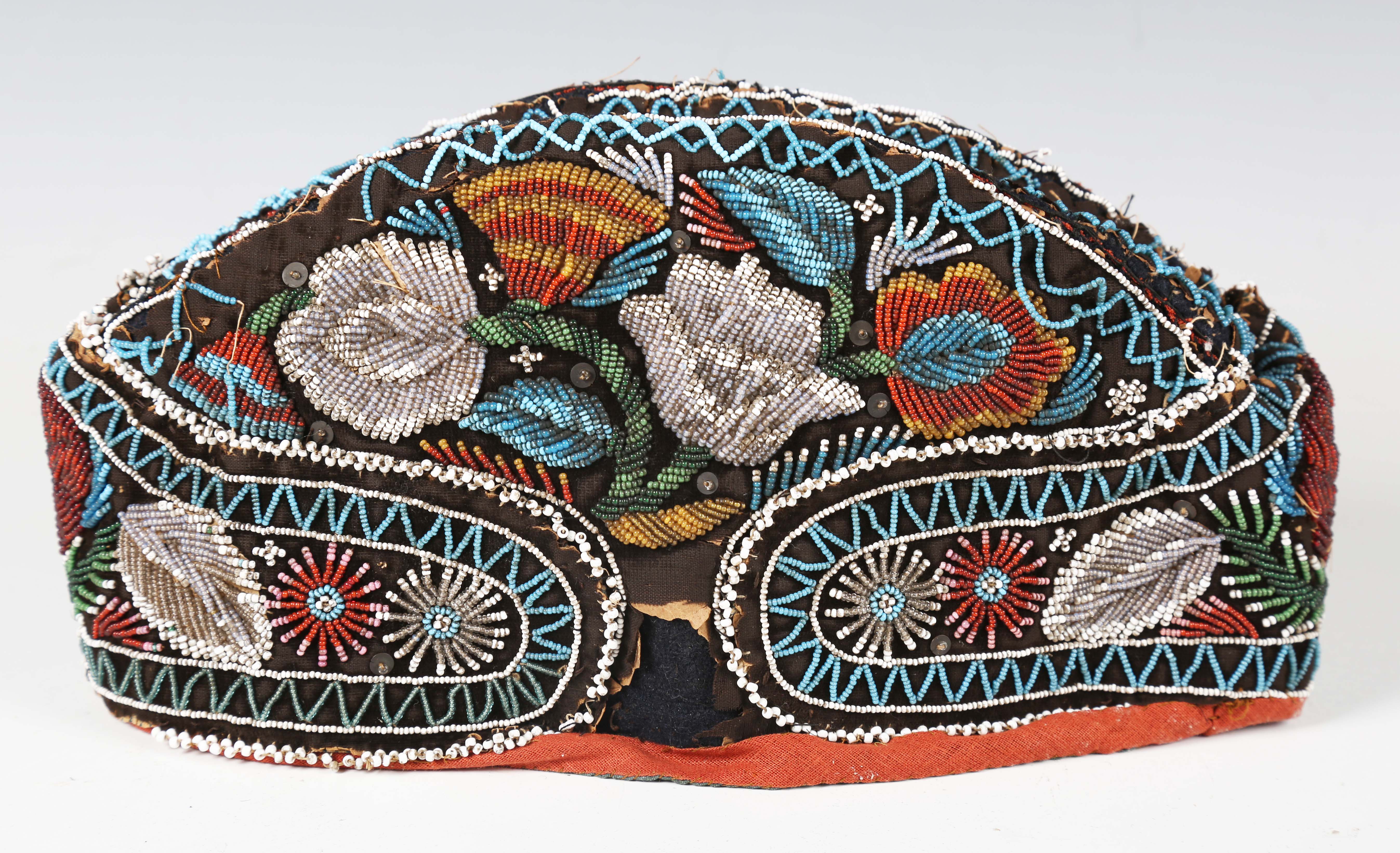 A 19th century beadwork and silk gentleman's cap, heavily beaded with flowers within zig-zag