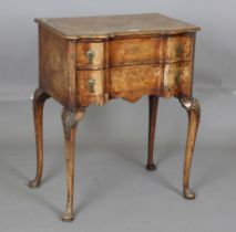 An early 20th century Queen Anne style walnut two-drawer side table, on shell carved cabriole