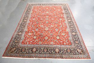 A Kashan carpet, Central Persia, late 20th century, the claret field with overall scrolling