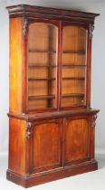 A mid-Victorian mahogany bookcase cabinet by James Winter & Son of London, the glazed top above