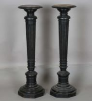 A pair of late Victorian ebonized display pedestals, on fluted supports, height 108cm.Buyer’s