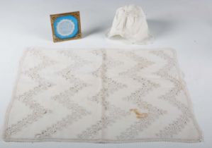 An 18th century linen infant's cap with hollie point lace insert, together with another framed