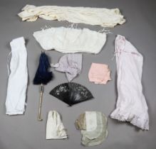 A selection of 19th and 20th century ladies' clothing and accessories, including two early bras,