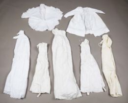 A collection of mid-19th century and later linen and silk babies' and infants' clothing, including
