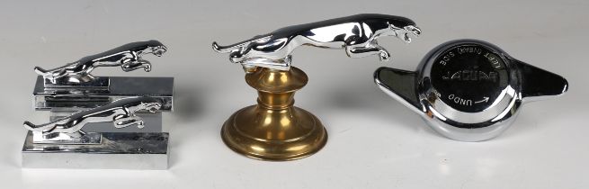 A chromium plated Jaguar car mascot, mounted on a brass pedestal, length 20cm, two other Jaguar