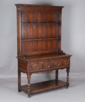 A 20th century Jacobean Revival oak dresser, the plate rack above two drawers, height 200cm, width