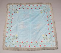 A Regency blue silk coverlet, embroidered in coloured silk with a border of flowers and applied with