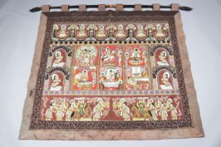 A Tibetan embroidered and appliqué wall hanging, worked in metal threads, coloured silks and sequins