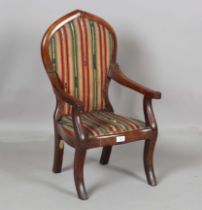 A mid-Victorian Gothic Revival mahogany showframe child's armchair, the arched top and sabre legs