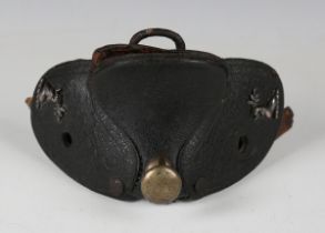 A late 18th century black leather and iron mounted saddle pommel with nickel finial and two